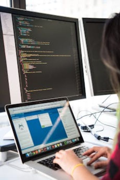 Person using both Computer and a Laptop